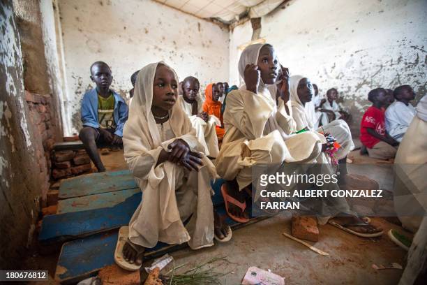 Students of Bakht Primary School in the camp for internally displaced people in Forobaranga, West Darfur, listen to a teacher during a class on...
