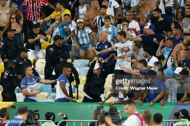 Police officers armed with batons clash with fans as the match is delayed due to the incidents prior to a FIFA World Cup 2026 Qualifier match between...