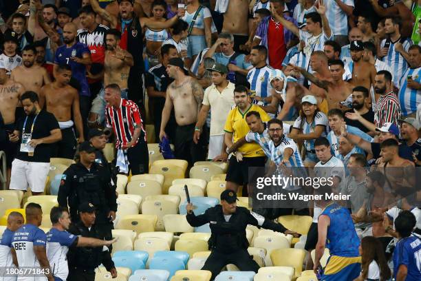 Police officers armed with batons clash with fans as the match is delayed due to the incidents prior to a FIFA World Cup 2026 Qualifier match between...