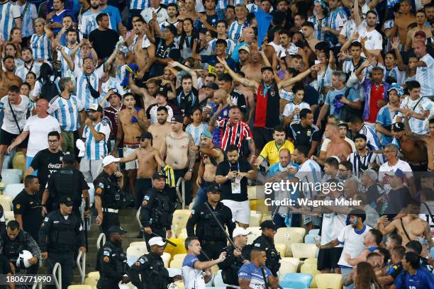 Police officers armed with batons clash with fans as the match is delayed due to the incidents prior to a FIFA World Cup 2026 Qualifier match between...