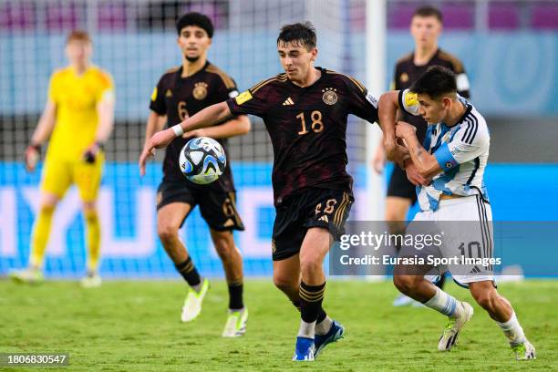 Claudio Echeverri of Argentina fights for the ball with Bilal Yalcinkaya of Germany during FIFA U-17 World Cup Semi final match between Argentina and...