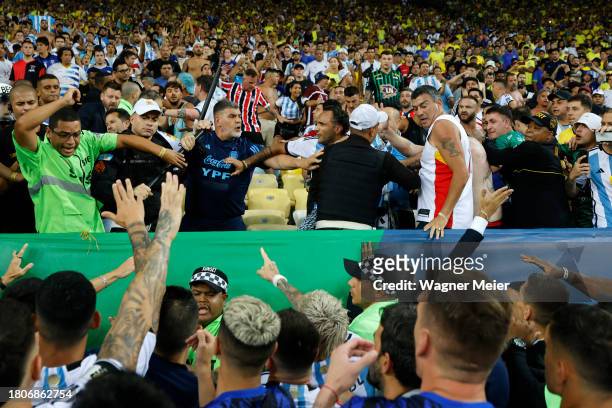 Rodrigo De Paul of Argentina and teammates react as police officers clash with fans prior to a FIFA World Cup 2026 Qualifier match between Brazil and...