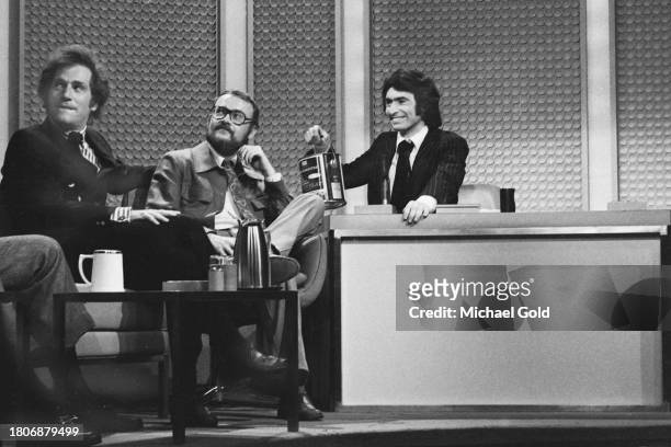 Actor George Segal, Writer and comedian Buck Henry and substitute host, David Steinberg, for The Tonight Show with Johnny Carson, gazing at someone...