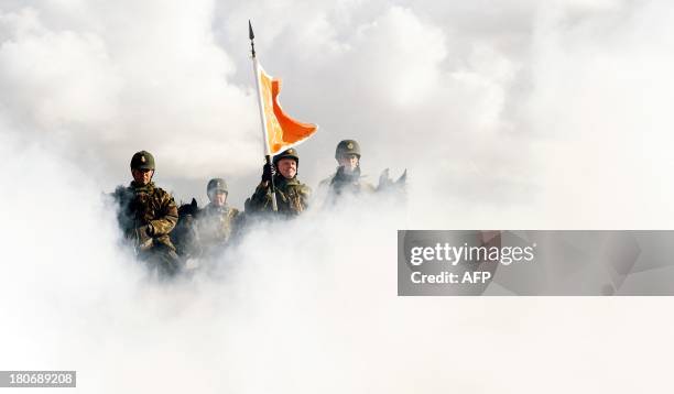 Dutch cavalry horses and their riders are exposed to smoke on September 16, 2013 as they undergo a stress test on the beach in Scheveningen. The...