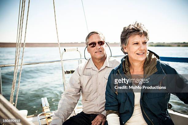 retired couple on sailboat - financial freedom stock pictures, royalty-free photos & images