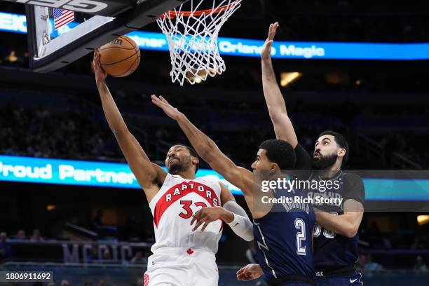 Otto Porter Jr. #32 of the Toronto Raptors has his shot blocked by Goga Bitadze of the Orlando Magic during the fourth quarter of an NBA In-Season...