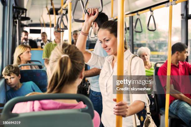 junge frau im gespräch mit ihrer freundin auf dem bus. - bus innen stock-fotos und bilder