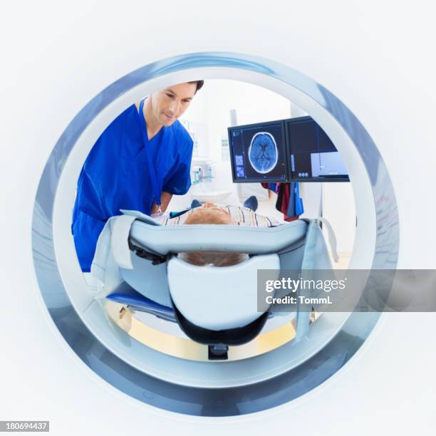 patient and doctor in cat scan - mri machine stockfoto's en -beelden