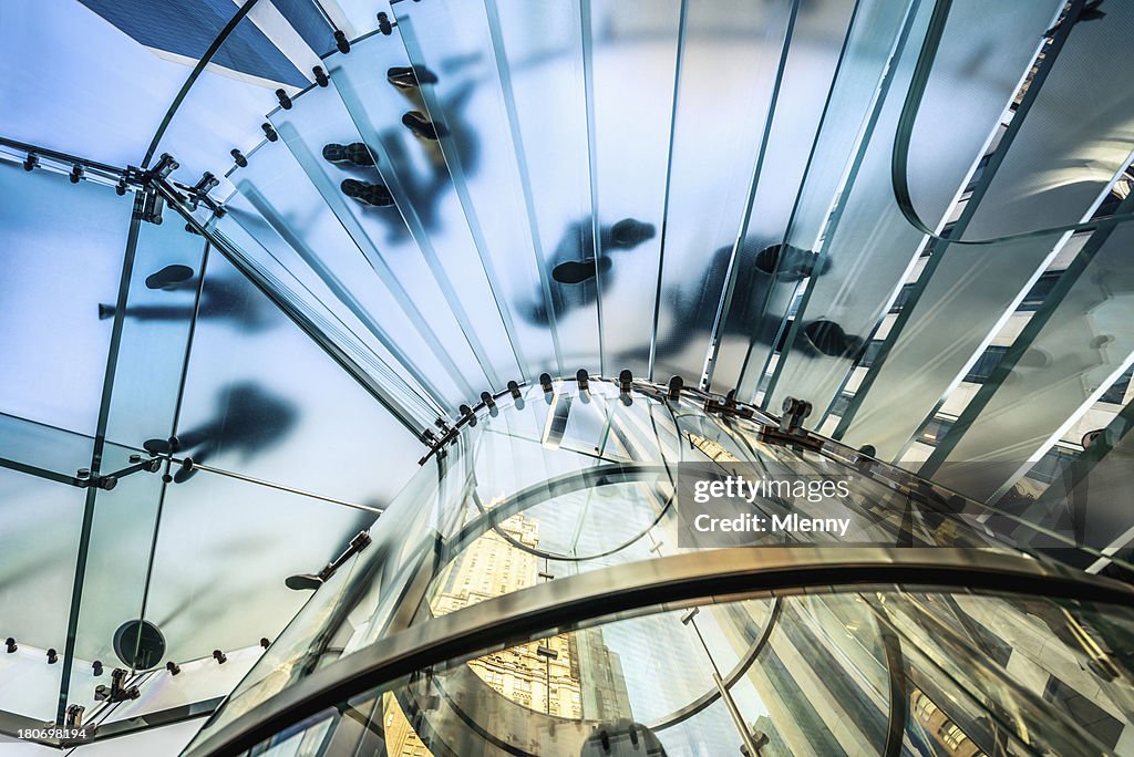 People walking on transparent glass staircase