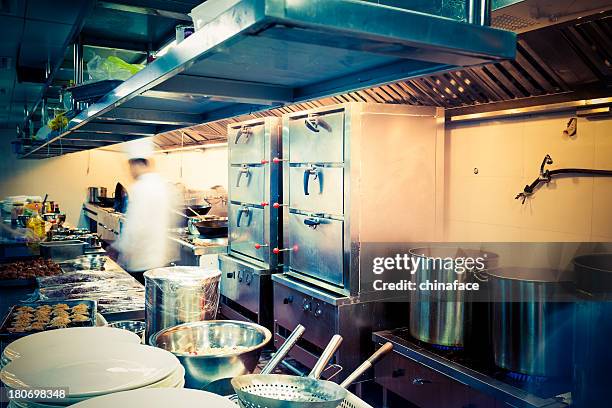 motion chefs  of a restaurant kitchen - crowded kitchen stock pictures, royalty-free photos & images