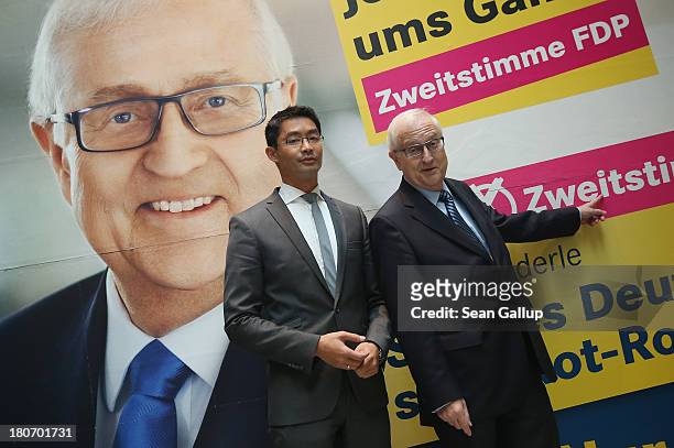 German Free Democrats lead candidate Rainer Bruederle and FDP party chairman Philipp Roesler stand in front of an FDP election campaign poster after...