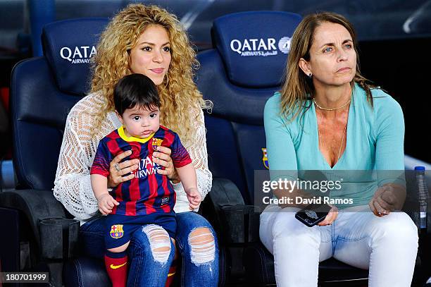 Shakira and Montserrat Bernabeu, Gerard Pique's mother, play with Milan prior to the La Liga match between FC Barcelona and Sevilla FC at Camp Nou on...