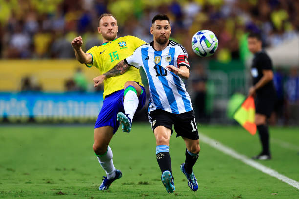 Lionel Messi of Argentina and Carlos Augusto of Brazil battle for the ball during a FIFA World Cup 2026 Qualifier match between Brazil and Argentina...