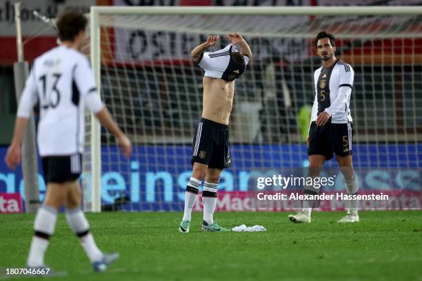 Joshua Kimmich of Germany reacts with Mats Hummels after Christoph Baumgartner of Austria scored the team's second goal during the international...