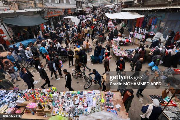 Crowds of people shop in an open-air market in the southern Gaza Strip city of Khan Yunis on November 28, 2023. In Khan Yunis, where the population...