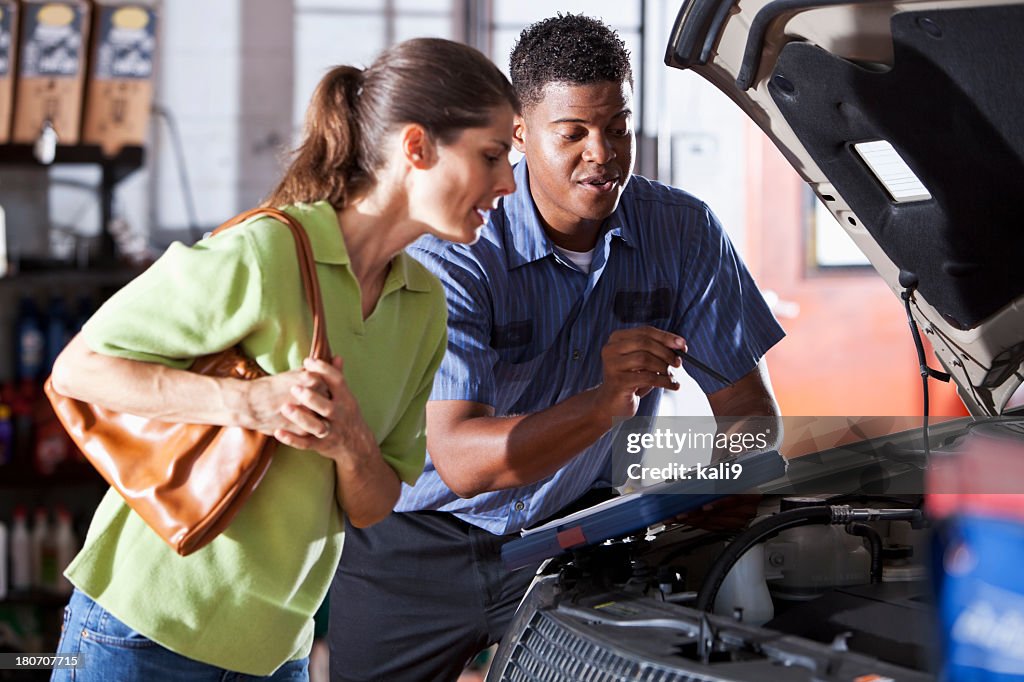 Auto mechanic with customer