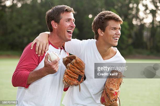 father and teenage son playing baseball - amateur baseball stock pictures, royalty-free photos & images