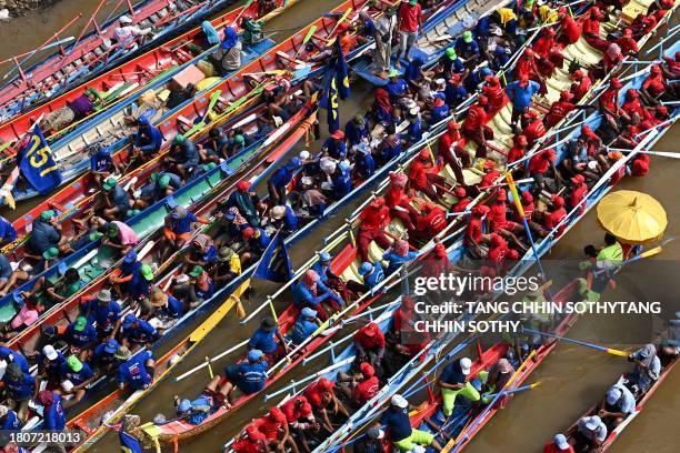 Participants wait before taking part in a a dragon boat race during the Water Festival on the Tonle Sap River in Phnom Penh on November 28, 2023.