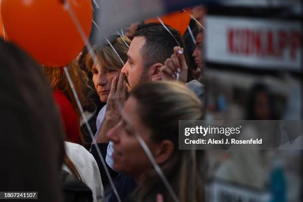 Relatives of the Bibas family and their supporters release orange balloons during a rally calling for the immediate release of Yarden Bibas, Shiri...