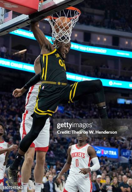 Jonathan Kuminga of the Golden State Warriors goes up for a slam dunk over Jock Landale of the Houston Rockets during the first quarter of an NBA...