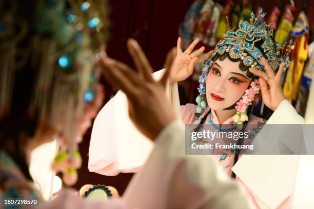 a chinese woman performing beijing opera on stage - peking opera stock pictures, royalty-free photos & images