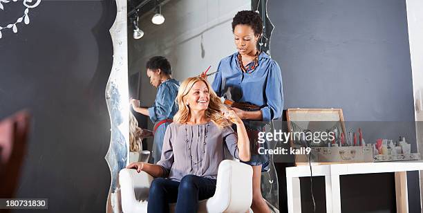 hairdresser in salon with customer - beauty salon stock pictures, royalty-free photos & images