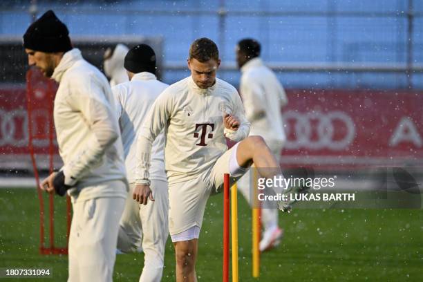 Bayern Munich's German midfielder Joshua Kimmich attends a training session during snowfall on November 28, 2023 in Munich, southern Germany, on the...
