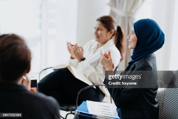 excited business people cheering and clapping during a meeting - malay people stock pictures, royalty-free photos & images