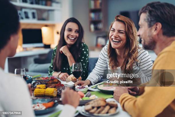 group of friends having good time together on a home party - house warming stock pictures, royalty-free photos & images