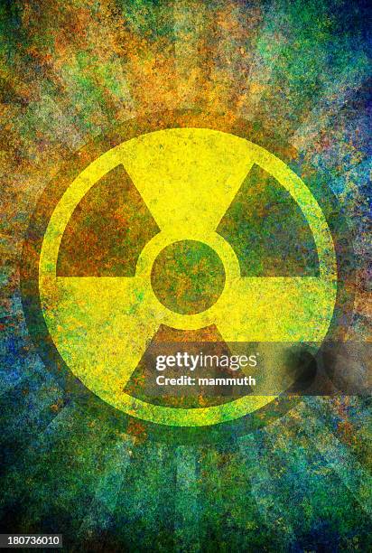 damaged radiation sign on grunge surface - gamma ray stock illustrations