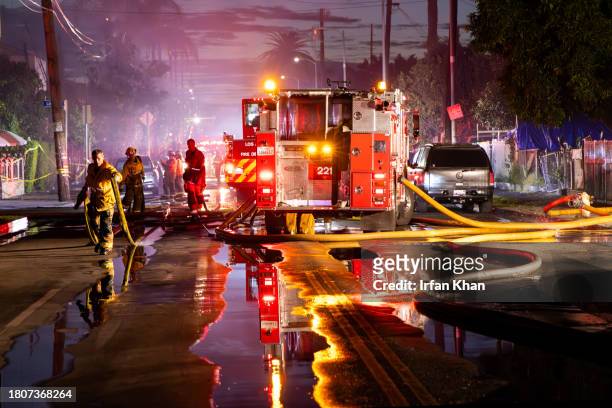 Firefighters fight a massive fire at an apartment building in the framing stages of construction caused evacuations of nearby residents at 1585 E....