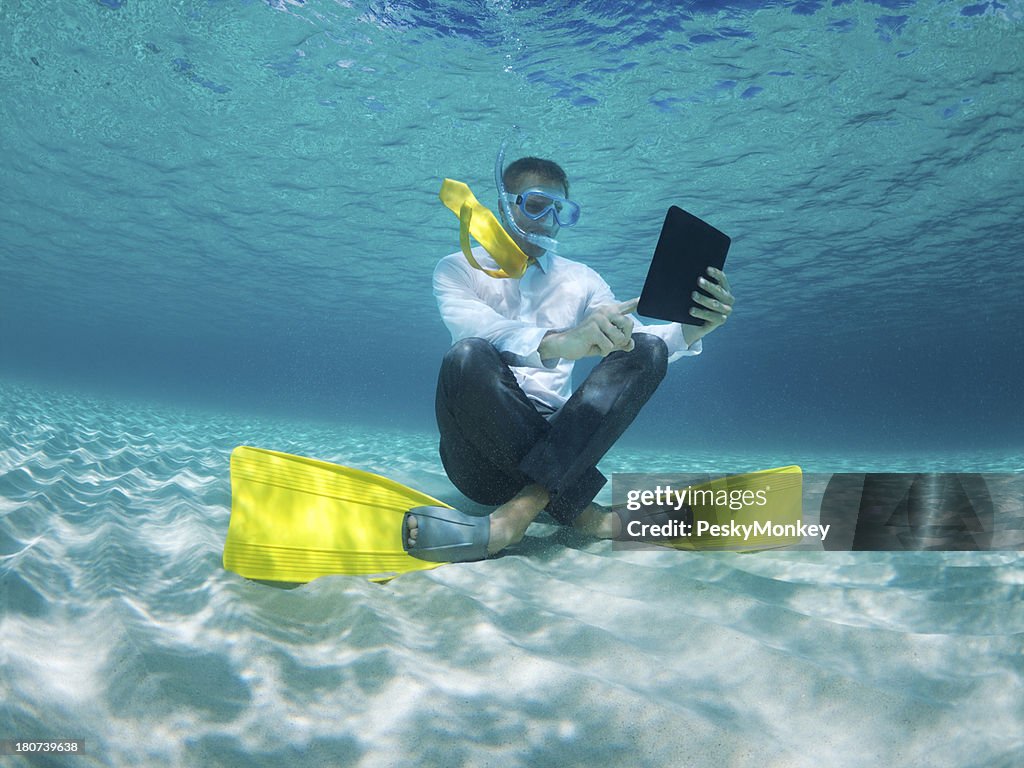 Traveling Businessman Using Digital Tablet Computer Underwater in Sea