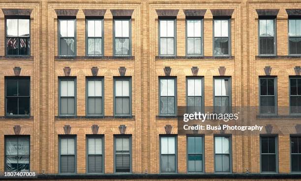 facade of former industrial building in the fort point area of boston, usa - fort point channel stock pictures, royalty-free photos & images