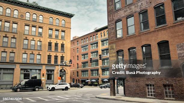 facades of former industrial buildings in the fort point area of boston, usa - fort point channel stock pictures, royalty-free photos & images