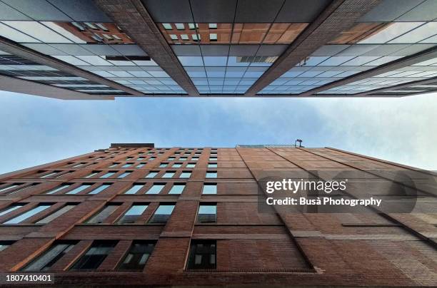 View from below of tall buildings in narrow alley