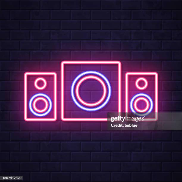 speaker sound system with subwoofer. glowing neon icon on brick wall background - surround sound stock illustrations