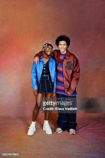 boy standing with arm around female friend - brown shoe stock pictures, royalty-free photos & images