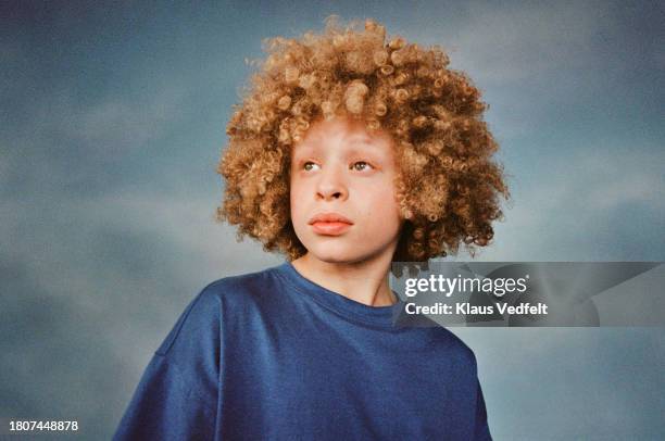 boy day dreaming against colored background - budding tween stock pictures, royalty-free photos & images