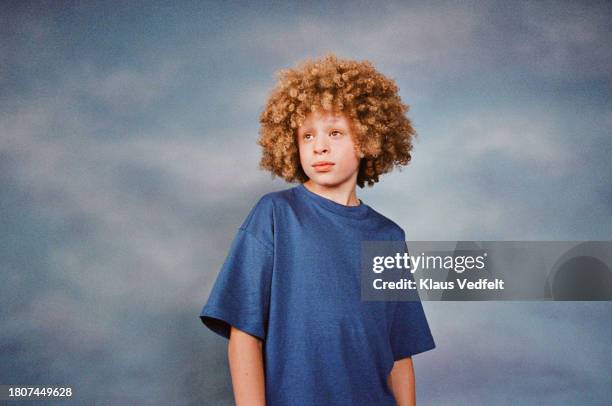 boy with curly hair against colored background - budding tween stock pictures, royalty-free photos & images