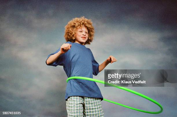 boy having fun while spinning hoola hoop - フープ ストックフォトと画像