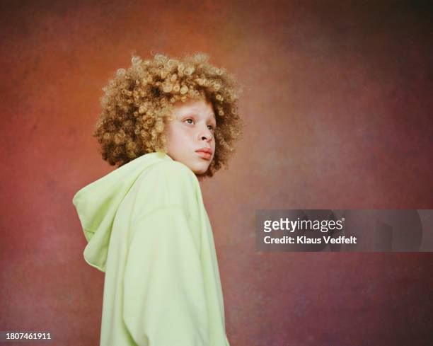 thoughtful boy against brown background - budding tween stock pictures, royalty-free photos & images