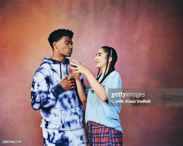 non-binary person discussing with male friend - bonding stock pictures, royalty-free photos & images