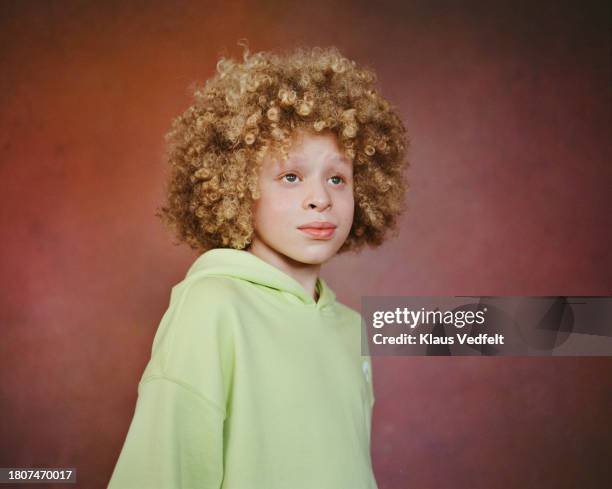 boy day dreaming against brown background - budding tween stock pictures, royalty-free photos & images