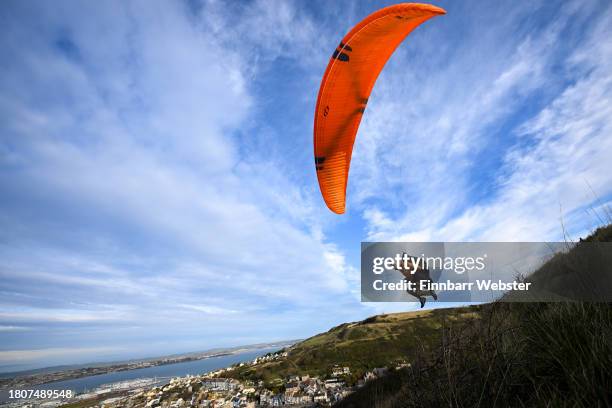 Paraglider flies from Portland Heights with the backdrop of the Jurassic Coast's Chesil beach, on November 22, 2023 in Portland, United Kingdom.