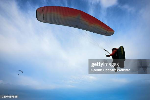 Paraglider flies from Portland Heights, on November 22, 2023 in Portland, United Kingdom.