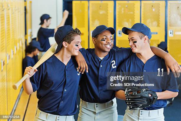 high school baseball team together in locker room after game - baseball team stock pictures, royalty-free photos & images