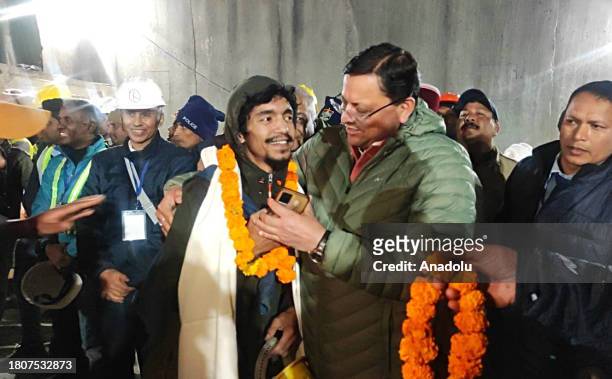 Uttarakhand Chief Minister Pushkar Singh Dhami with the rescued worker inside the tunnel on the Brahmakal Yamunotri National Highway in Uttarkashi,...