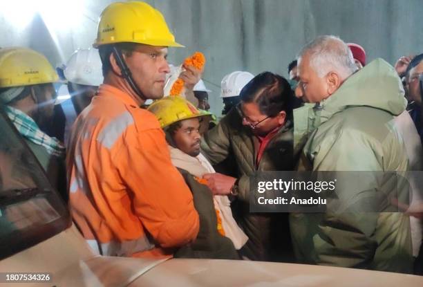 Uttarakhand Chief Minister Pushkar Singh Dhami with the rescued worker inside the tunnel on the Brahmakal Yamunotri National Highway in Uttarkashi,...