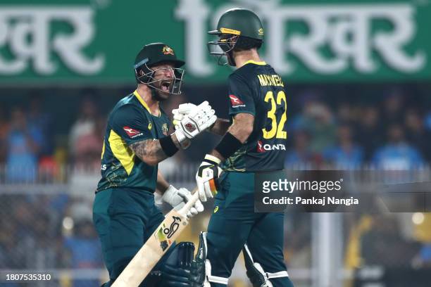 Matthew Wade captain of Australia and Glenn Maxwell of Australia celebrate their team's win over India during game three of the T20 International...