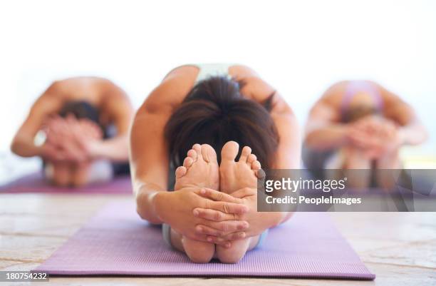 stretching to the max - touching toes stock pictures, royalty-free photos & images